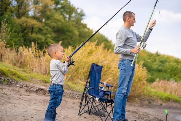 A happy family spends time together; they teach their son to fish.