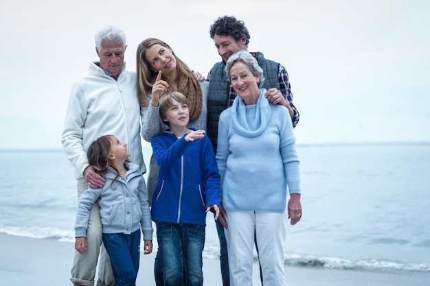 Happy family standing at beach