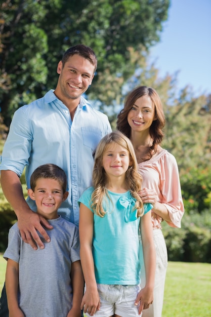 Happy family standing in the countryside