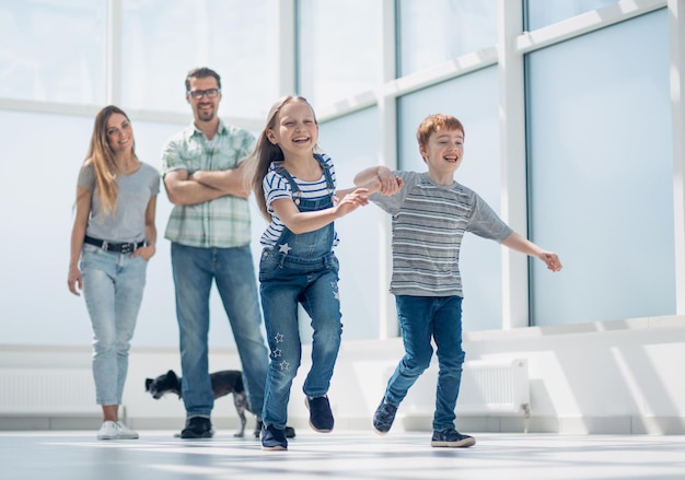 Happy family standing in new spacious apartmentphoto with copy space