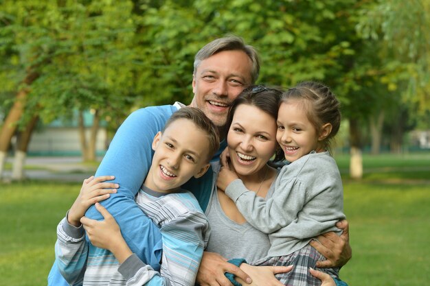 Happy family at summer green blooming field