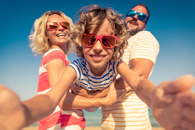 Happy family on summer vacation People having fun on the beach Active healthy lifestyle