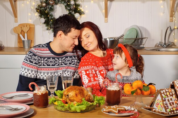 Happy family at the table on new year\'s eve.