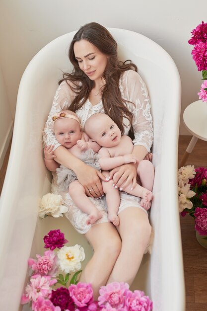 Happy family taking a bath in floral water