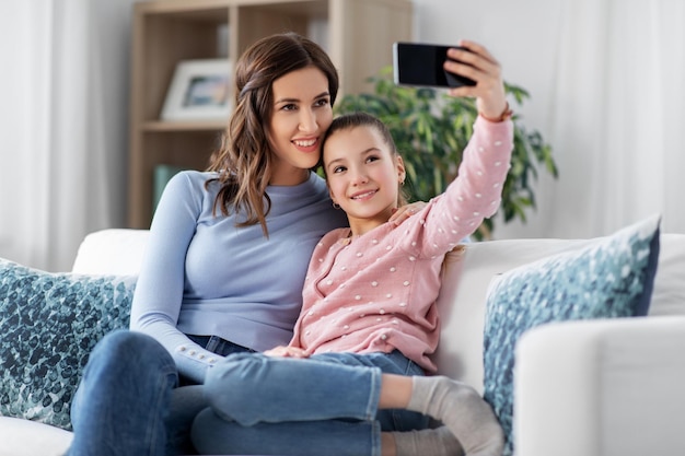 happy family taking selfie by smartphone at home
