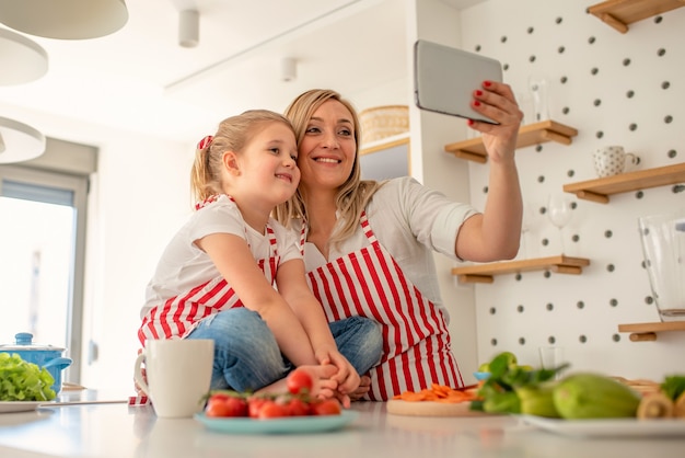 Happy family taking a selfie together while cooking