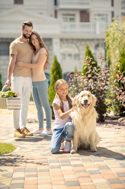 Happy family taking a walk together with their dog