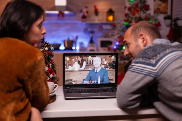 Happy family talking with remote grandfather during online videocall meeting