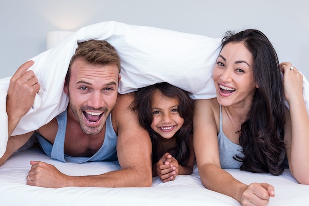 Happy family in their bedroom