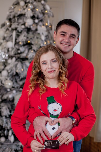 Happy family in their living room near Christmas tree