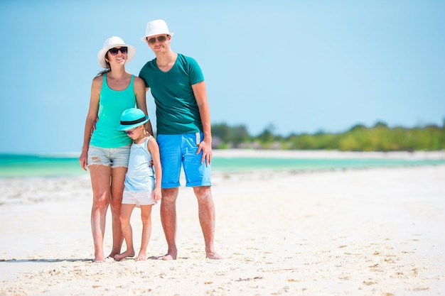 Happy family of three on a beach during summer vacation