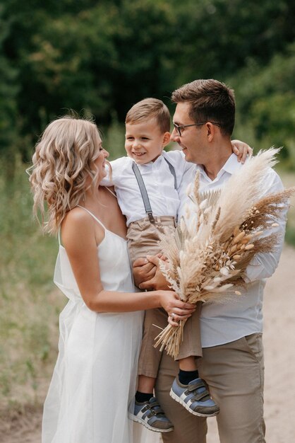 Foto famiglia felice tre papà mamma e figlio in una passeggiata