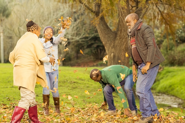 Happy family throwing leaves around