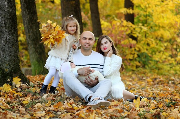 Happy family together in yellow nature Autumn day