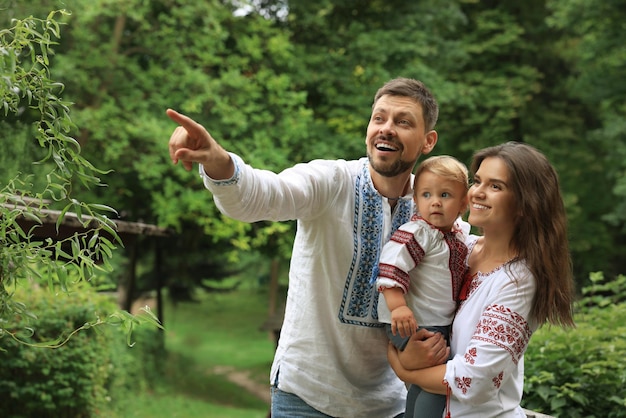 Happy family in Ukrainian national clothes outdoors