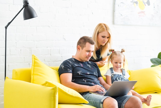 Photo happy family using laptop at home