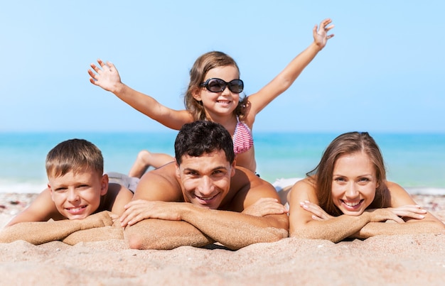 Happy family on vacations on beach background