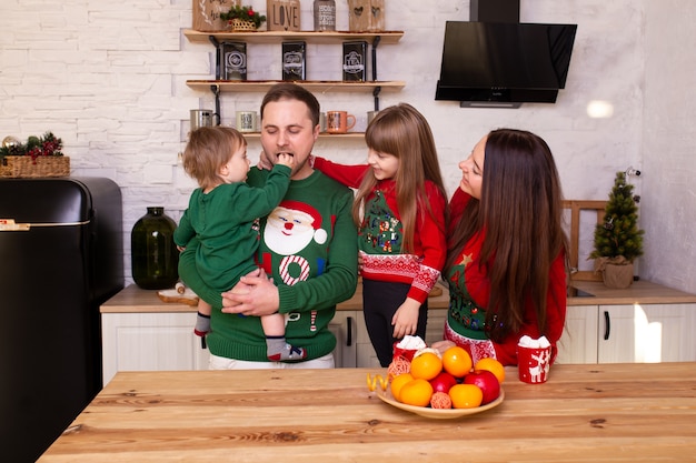 Happy family waiting for Christmas at home in kitchen