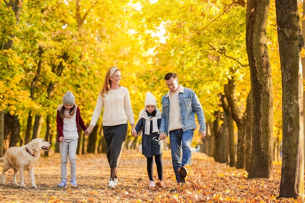 Happy family walking in autumn park