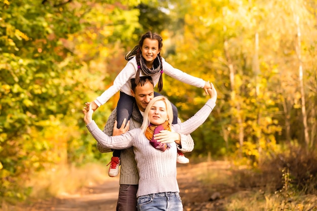 happy family walking in the autumn park