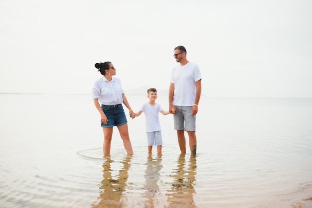 Happy family walking on the beach