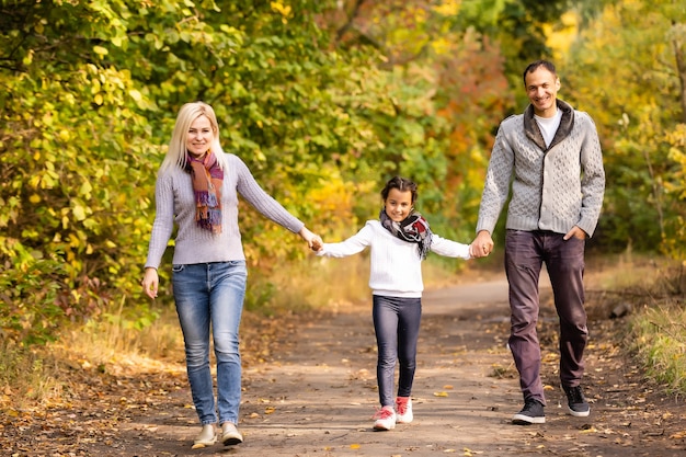 happy family Walking through autumn park