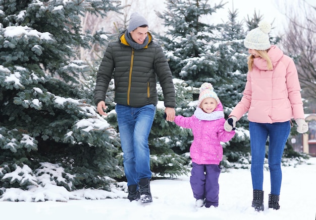 Happy family walking in winter park