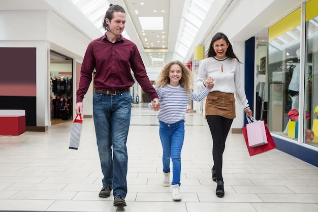 Happy family walking with shopping bags