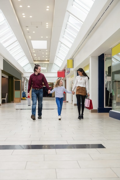 Happy family walking with shopping bags