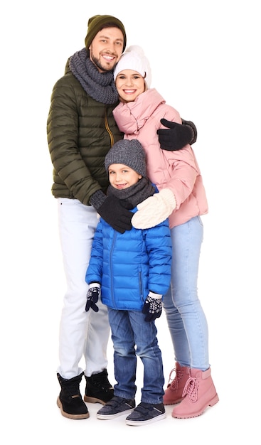 Happy family in warm clothing on white background.