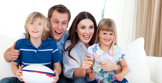 Happy family watching a rugby match 