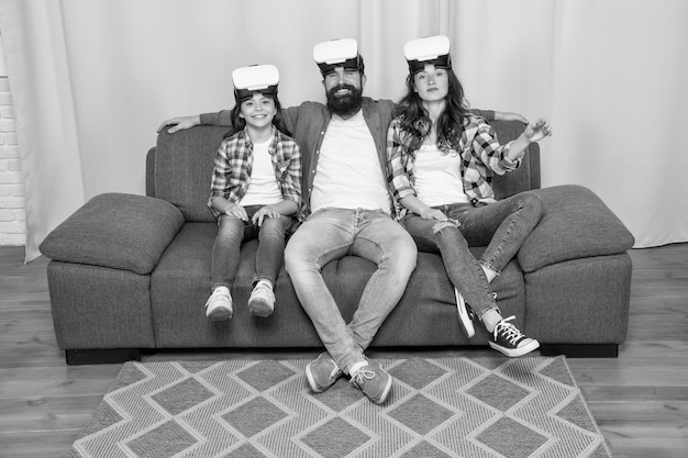 Happy family wear vr glasses sitting on sofa at home family