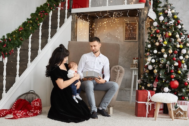 Happy family with a baby celebrating Christmas