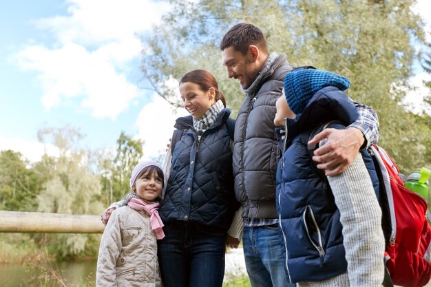 happy family with backpacks hiking