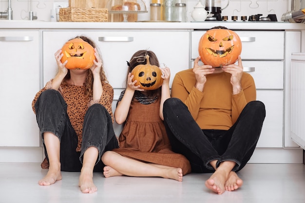 Happy family with carving pumpkin