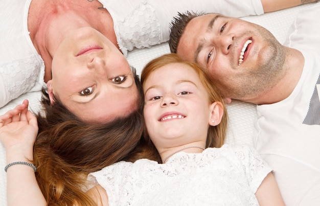 Happy family with child in bed