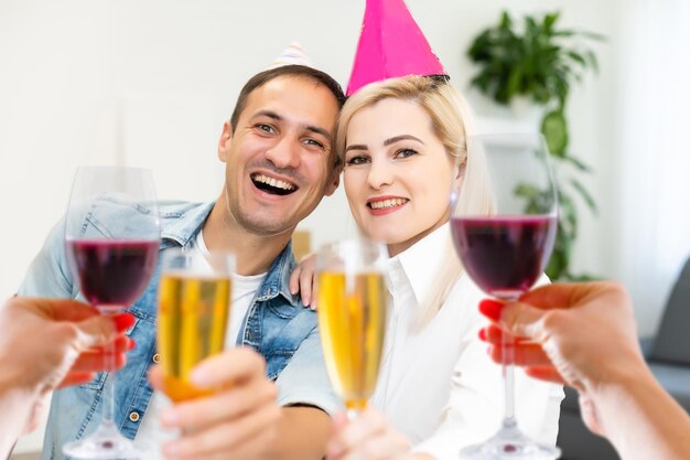 A happy family with a child is celebrating Christmas with their friends on video call using webcam. Family greeting their relatives on Christmas eve online. New normal virtual event