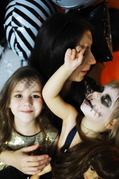 Happy family with childrens in costumes and makeup on celebration of Halloween