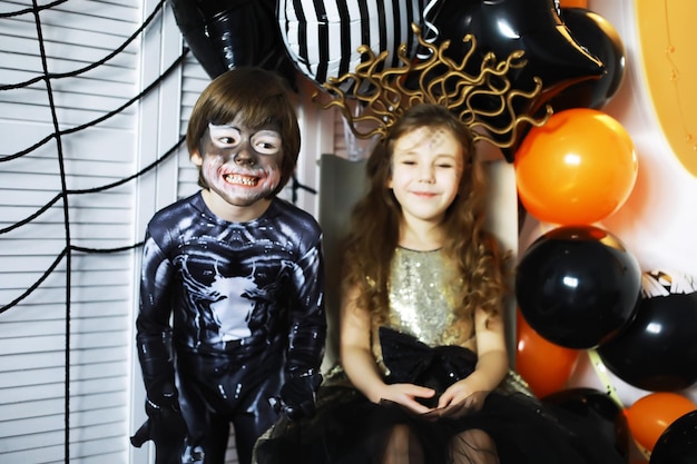 Photo happy family with childrens in costumes and makeup on celebration of halloween