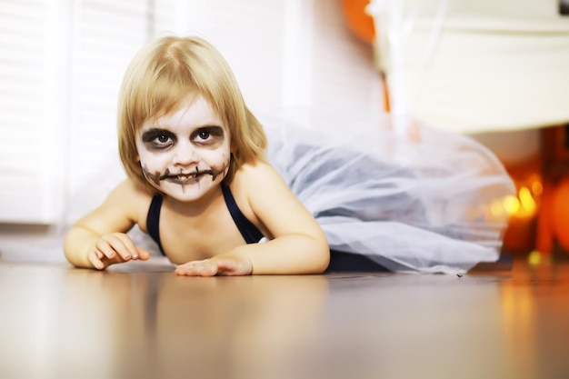 Happy family with childrens in costumes and makeup on a celebration of Halloween