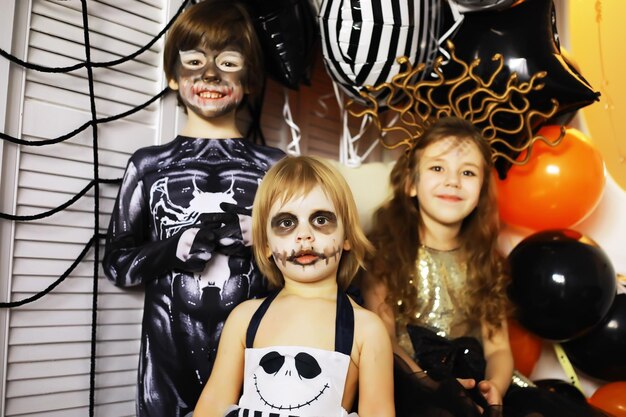 Happy family with childrens in costumes and makeup on a celebration of Halloween