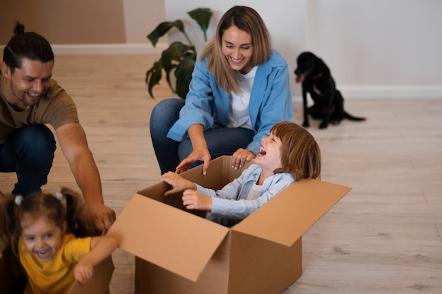 Happy family with dog moving in new home