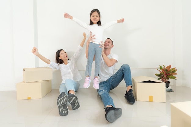 Happy family with girl moving into a new home