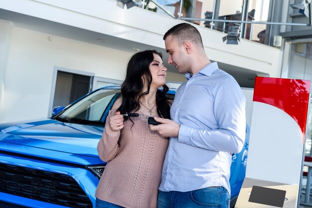 Happy family with keys from new car