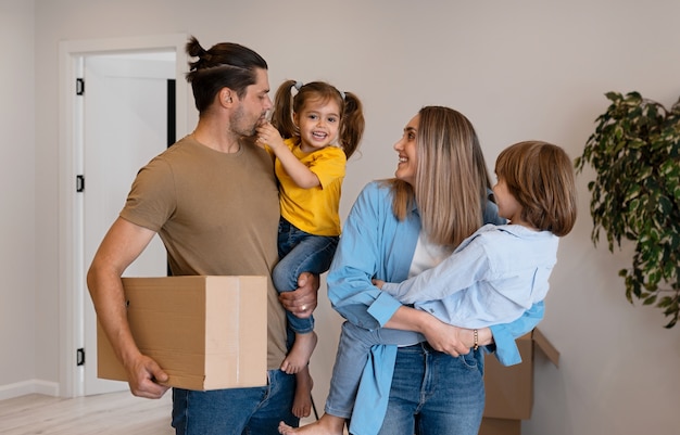 Happy family with kids moving in their new home