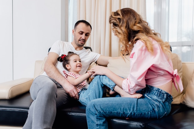 Happy family with little daughter having fun at home. summer vacation. 