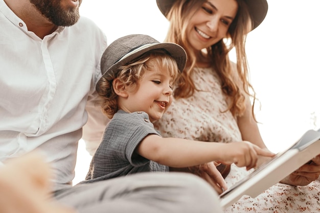 Happy family with son reading book