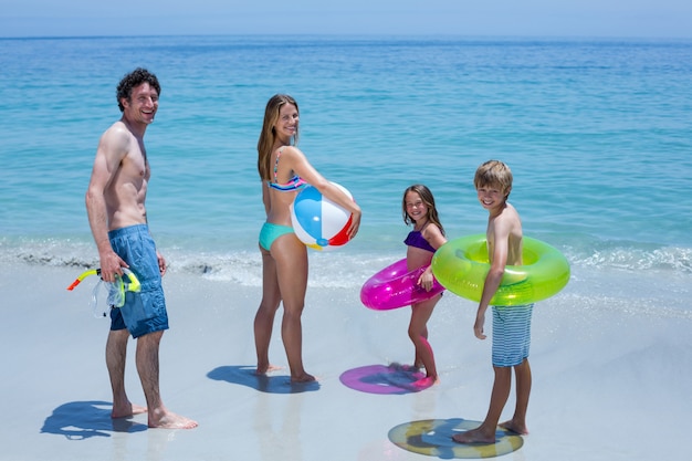 Happy family with swimming equipment at sea shore