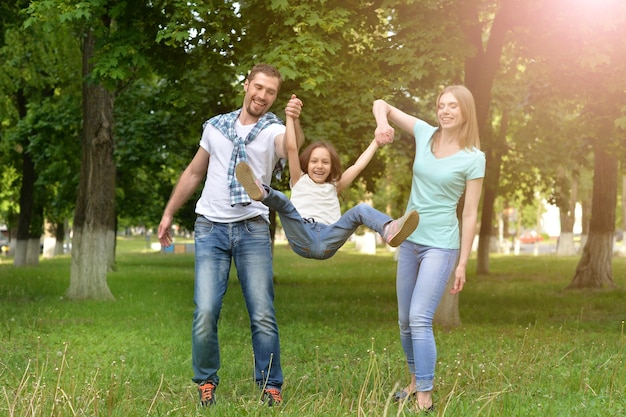 Happy family with their little daughter in the park