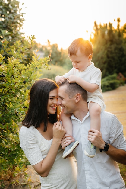 Happy family with their son walking in the Park at sunset. Happiness. Love